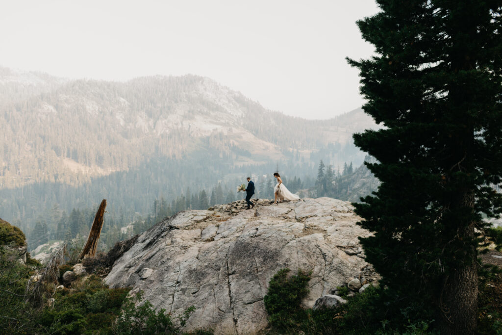 Bride and Groom walking along a granite ridge at White Wolf Tahoe
